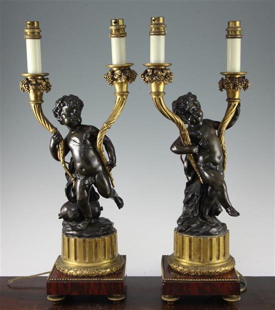 A pair of 19th century French bronze and ormolu twin branch candelabra, 21in., fitted for electricity